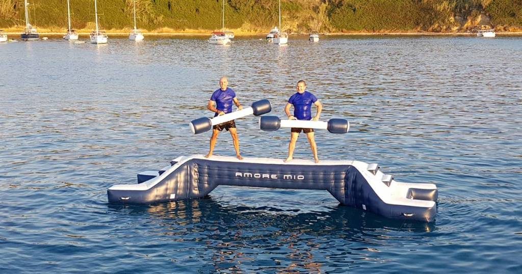 FunAIr Water Joust superyacht Toy with two yacht crew stood on balance beam holding inflatable battle poles
