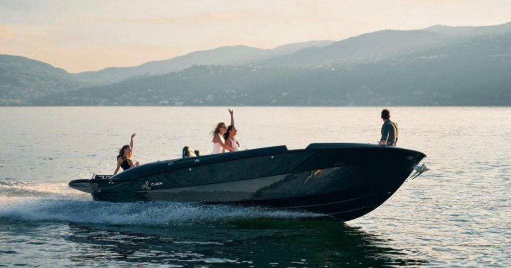Women dancing on superyacht tender cruising into the sunset