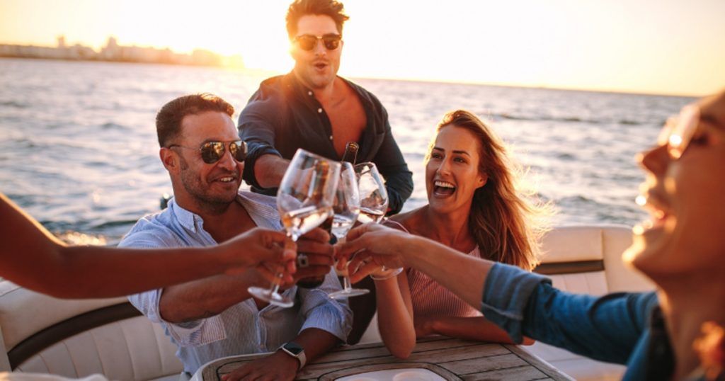 Superyacht Crew relaxing with drinks at sunset