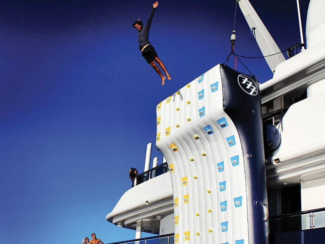 Man jumping off Climbing Wall on MY Triple 7