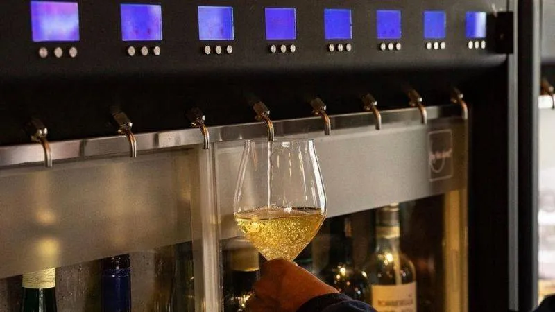 Pouring a drink from a wine tap