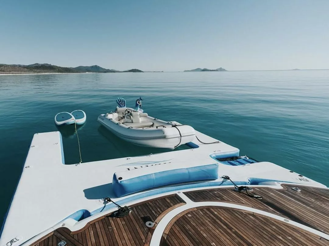 An inflatable RIB and SUPs attached to the Custom Jet Ski Dock on superyacht Alani