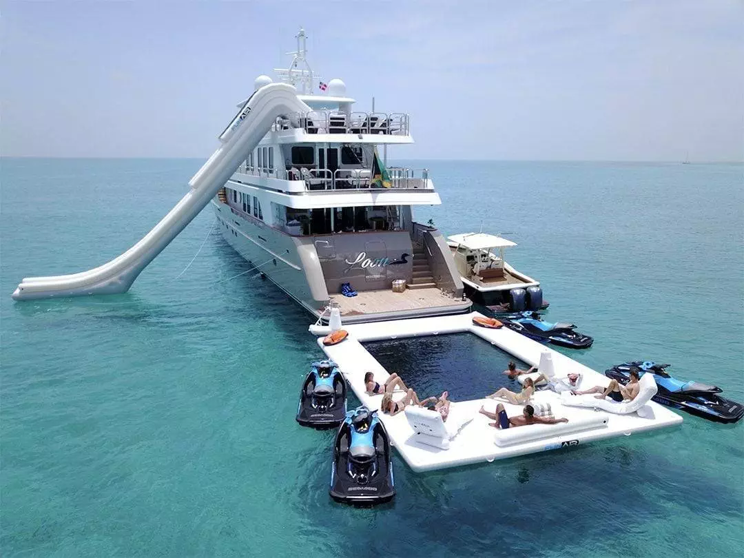 Charter Guests enjoying the Custom Beach Club Sea Pool on luxury superyacht