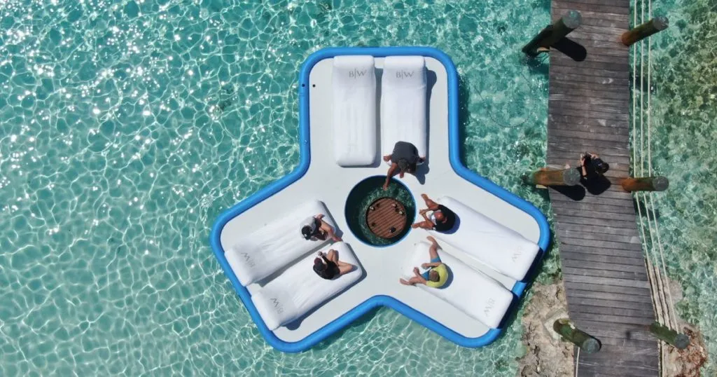 Motoryacht Broadwater charter guests on a FunAir Floating Island with Beach Loungers attached in crystal clear water